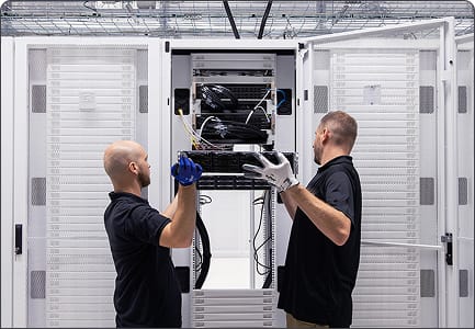 Photo of CUDO engineers working in the data center, representing the Run phase of CUDO's delivery process
